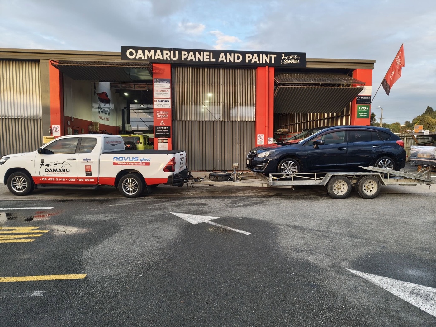 Oamaru Panel and Paint recovery ute towing a vehicle at the workshop